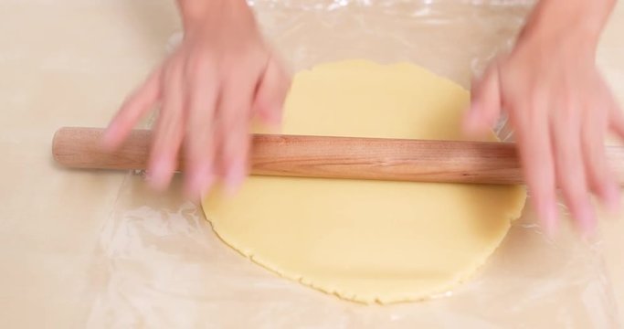Chef rolling dough with rolling pin