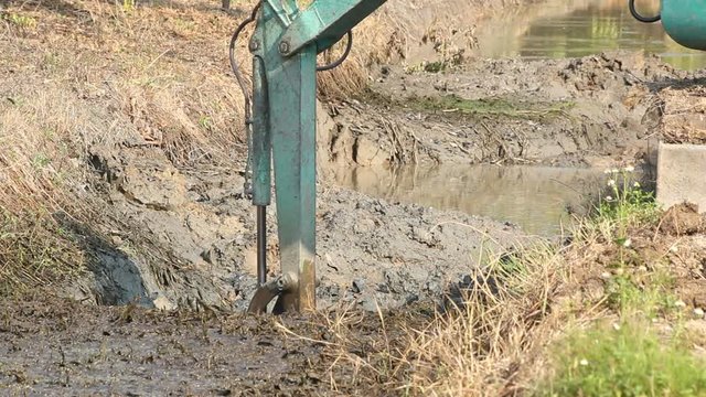 backhoe digging river