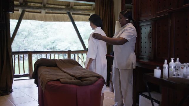  Beauty therapist giving a relaxing treatment to woman at a spa resort
