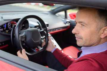 proud man in his new car