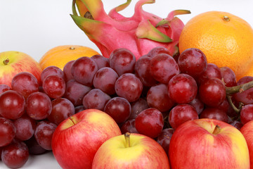Mixed fruits as Red seedless grapes,orange,apple,Dragon fruit,Japanese golden melon.