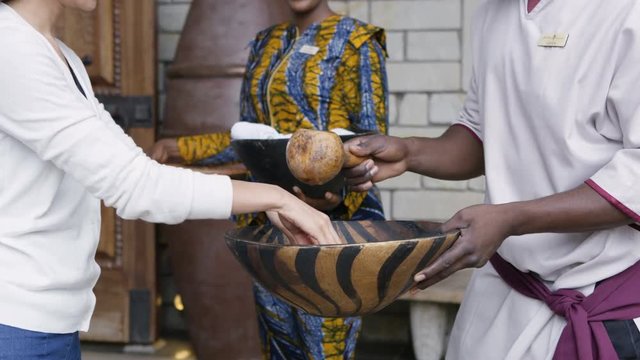  Couple on African vacation being greeted by friendly staff at hotel