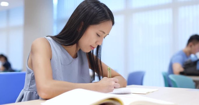 Student doing homework in university campus