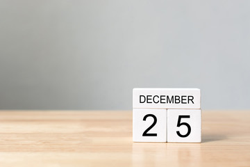 Wooden block calender 25th December on wood table with white wall background, Happy Christmas holiday celebration concept, Copy space your text