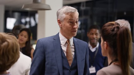  Diverse business group talking and networking at a business conference - Powered by Adobe