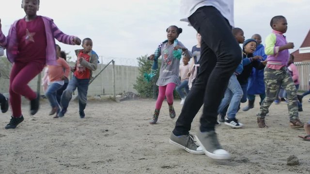 Volunteers from South African charity playing outdoors with local children