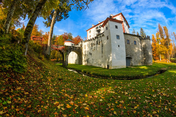Fototapeta na wymiar The picturesque 13th-century Sneznik Castle (Grad Snežnik, Schloß Schneeberg) in autumn, located in Loška Dolina, Slovenia