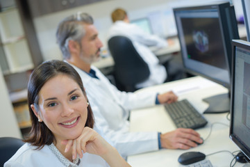 Portrait of woman next to computer