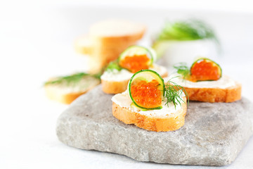 Sandwich with ricotta, a cucumber, caviar .