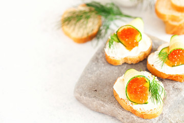 Sandwich with ricotta, a cucumber, caviar .