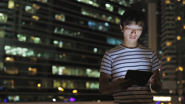 Man Using Tablet Computer At Night