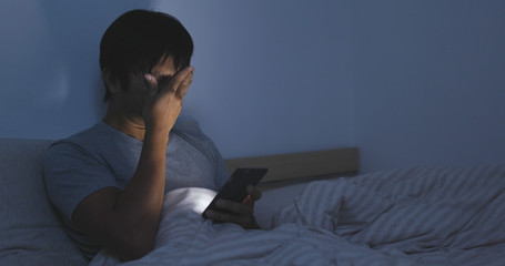 Man use of cellphone and feeling eye pain