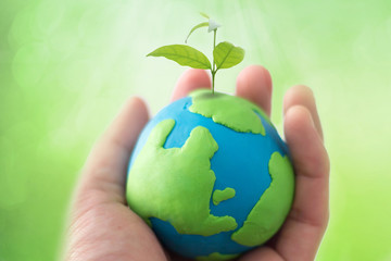 Planting tree in green globe , Environment conservation ,CSR Abbreviation or Corporate Social Responsibility