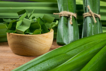 Pandan and pandan leaves in a wooden cup prepared for pandan juice or pandan cake to boil or dried Before going to cooking.Shot in the studio