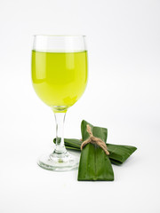 Pandan and pandan juice is made from the crushed or boiled. It health drink in clear glass.isolate on white background