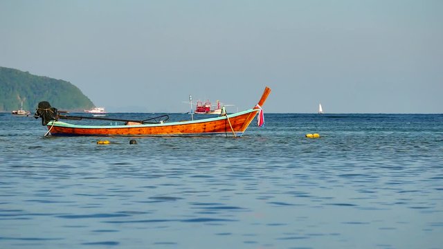 A fishing boat or Long-tail boat floating in the sea after fishing in transportation concept, UHD or 4K Resolution.