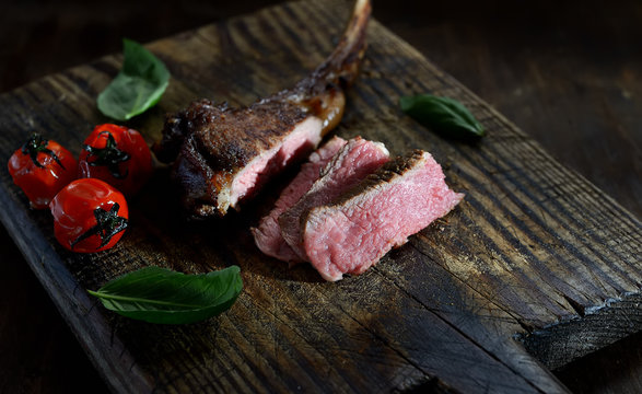 grilled lamb steak  on a wooden background.