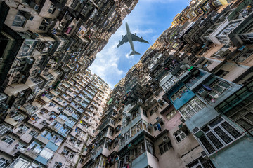 HongKong. Airplane flying over old tall and dense residential building in Hong Kong.