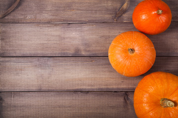 Pumpkins over old wooden background with copy space