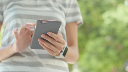 Woman use of mobile phone over green background
