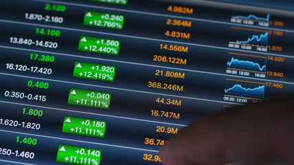 Fototapeta premium Man checking stock market on tablet