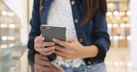 Woman use of smart phone in shopping mall