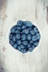 Vintage photo, Fresh blueberries in glass bowl, natural source of minerals, healthy dessert concept