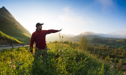 Fototapeta premium Man on top of mountain. Conceptual scene.