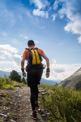Fototapeta na wymiar Man trail running in the mountain in Altai, Russia