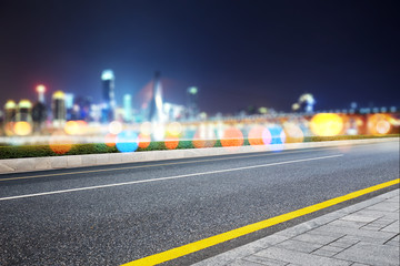 empty asphalt road with modern bridge and buildings