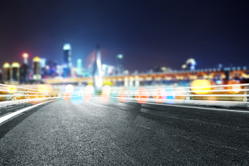 empty asphalt road with modern bridge and buildings