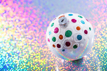 christmas white bauble on rainbow color background with copy space. xmas postcard