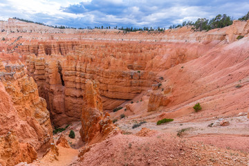 Spectacular view at the cliffs and cloud sky. Amazing mountain landscape. Breathtaking view of the canyon. Bryce Canyon National Park. Utah. USA