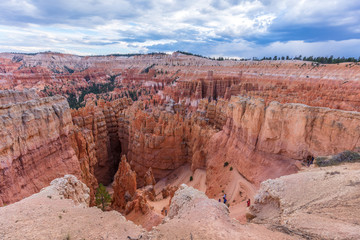 Fototapeta na wymiar Spectacular view at the cliffs and cloud sky. Amazing mountain landscape. Breathtaking view of the canyon. Bryce Canyon National Park. Utah. USA