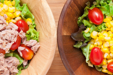 Tuna salad and Corn salad on wooden table.