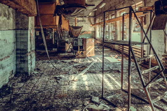 Destroyed And Abandoned Factory Shop, Complete Mess And Desolation. Remains Of Equipment And Interior.