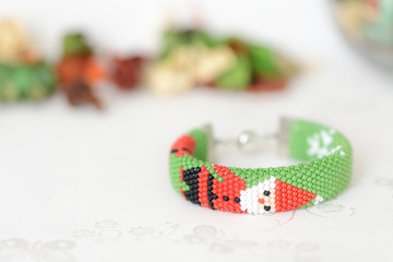 Green Christmas bracelet with image of Santa close up