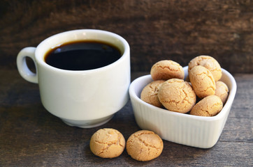Amaretti cookies.Typical Italian almond amarettini biscuits and cup of coffee.Selective focus.