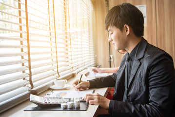 businessman working on documents graphic concentrated with mobile phone on the table at office.