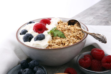 Bowl of homemade granola with yogurt and fresh berries