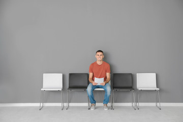 Fototapeta premium Young man waiting for job interview in hall
