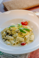 Italian food - rigatoni pasta with basil and black truffle.