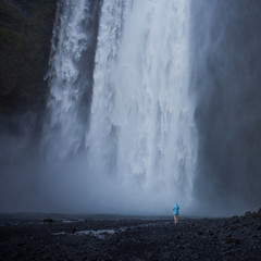People in the background of Skogafoss waterfall in Iceland