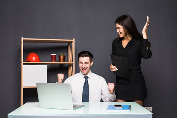 Young office workers in front of desktop computer in office