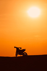 Silhouette of a motobike on sunset