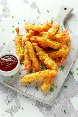 Fried Shrimps tempura with sweet chili sauce on white wooden board