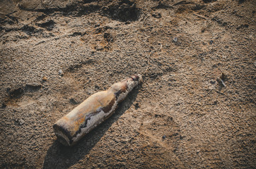 Broken empty bottle of beer on the ground