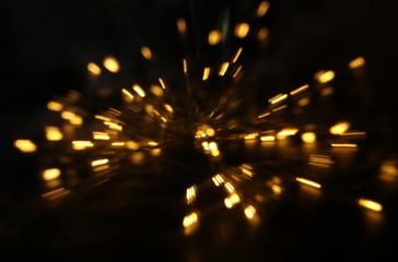 abstract bokeh background of golden light burst made from bokeh motion