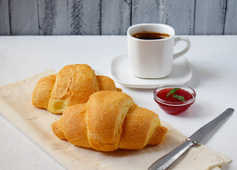 Breakfast with coffee and croissants