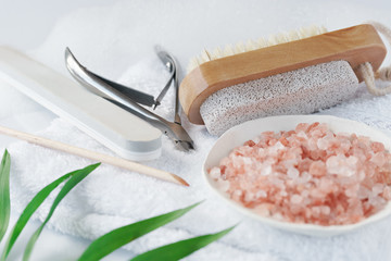 image of legs care theme. brush, pumice, salt, foam, towel on white background